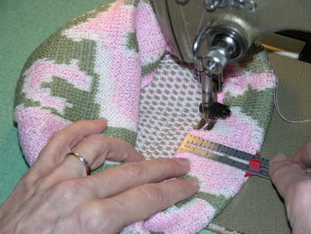 Sew the bottom hem of the knit camo baby beanie