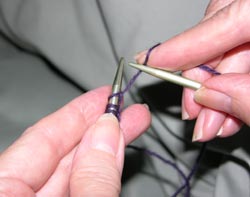 Hold the knitting needle in the right hand with the thumb and index finger as if you are holding a pencil