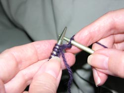 This completes the first stitch and a new row of knitting is being formed on the right hand needle