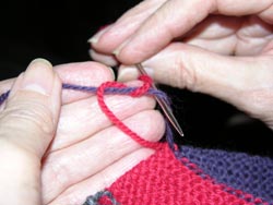 Photo of For a Surgeon's knot the left yarn has been wound around the right end yarn two times