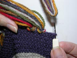 Hook the middle of the 7 strands of yarn with your latch tool or crochet hook