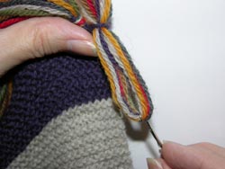 Pull the strand of yarn through the Scarf Edge far enough to create a circular loop.